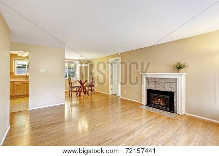 Empty House Interior With Cozy Fireplace And Dining Area