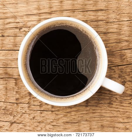 Black Coffee In White Ceramic Cup On Wooden Table