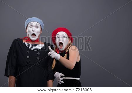 Portrait of sad mime couple crying isolated on grey background