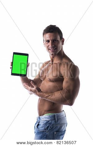 Shirtless young male bodybuiler holding ebook reader or tablet PC
