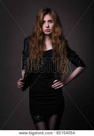 Attractive Woman In Black Dress And Leather Jacket