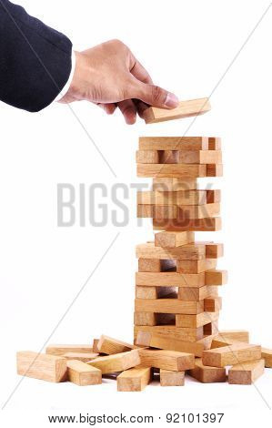 Businessman Playing With The Wood Game (jenga).