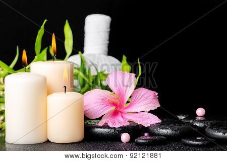 Spa Setting Of Hibiscus Flower, Twig Bamboo, Thai Herbal Compress Balls, Beads And Candles On Zen Ba