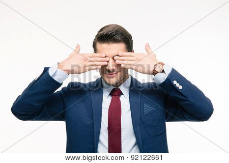 Businessman covering his eyes isolated on a white background