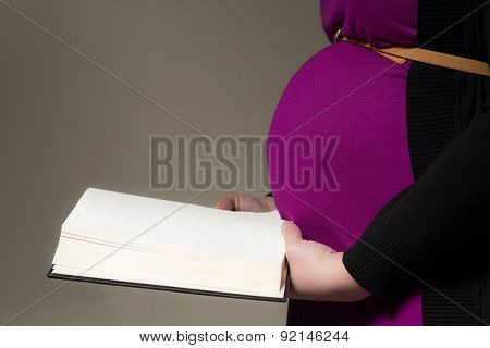 Expecting Mom Holding The Holy Bible