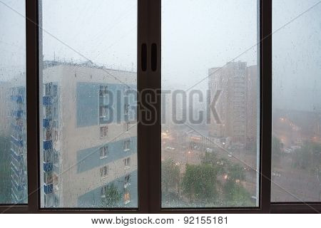 Raindrops On Urban House Wndow During Rain