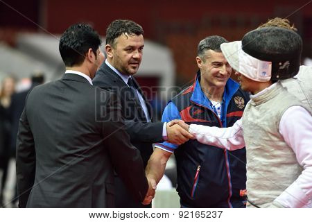 ST. PETERSBURG, RUSSIA - MAY 3, 2015: Italian team handshakes with judges after team semifinal of International fencing tournament St. Petersburg Foil. The tournament is the stage of FIE World Cup