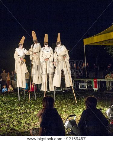 People On Stilts Perform Romeo And Juliet  Wearing Carnival Costumes