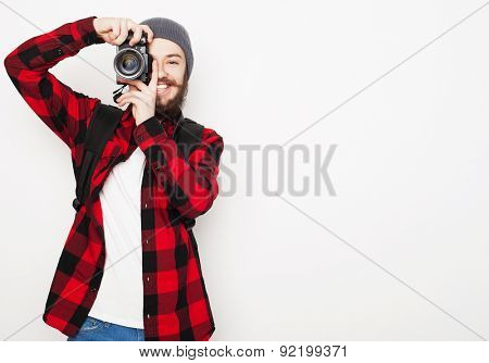 life style, tehnology and people concept: professional photographer. Portrait of confident young man in shirt  holding  camera over white background