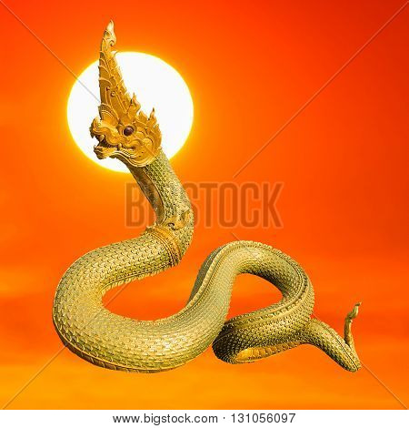 Naga Thai statue with beautyful sunset background