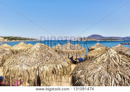 View of the bay and the sun umbrella on the Greek island of Crete
