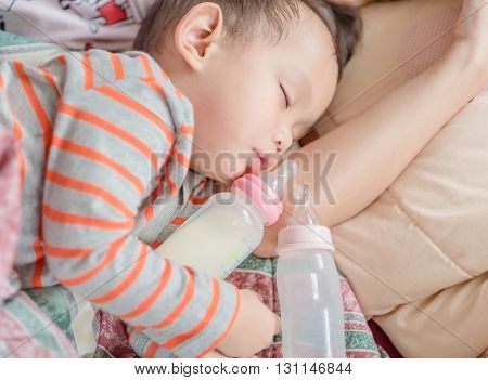 Asian Baby Boy Sleeping In Mother Arm