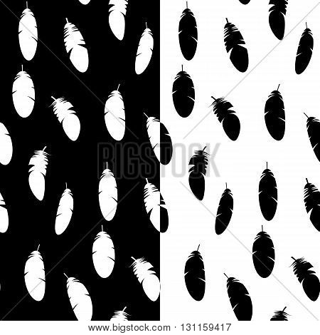 Black and white vector seamless patterns with feathers in two variations. White feathers on black background. Black feathers on white background.