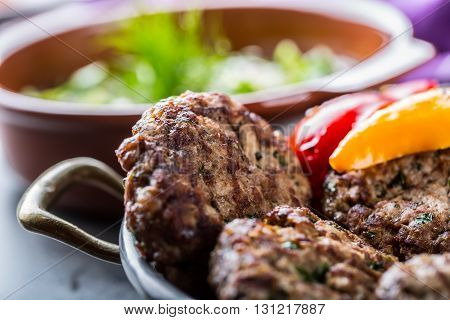 Burgers. Grill burgers. Minced burgers. Roasted burgers with grilled vegetable and herb decoration. Minced meat grilled in a hotel or restaurant.