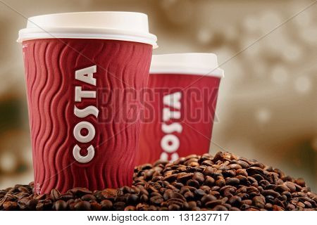 Composition With Cup Of Costa Coffee Coffee And Beans