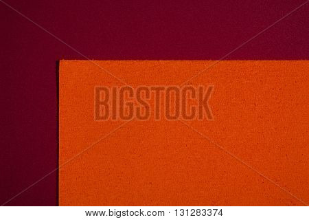 Eva foam ethylene vinyl acetate sponge plush orange surface on red smooth background