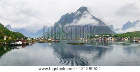 Scenic view of Reine - fishing village with red houses in the morning. Beauty of Rorbu, Lofoten islands, Norway