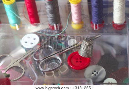 sewing kit spools of thread scissors thimble tailor buttons needles and pins