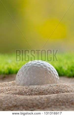 Close up Golf ball in sand bunker