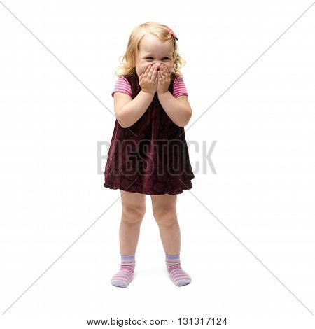 Young little girl with curly hair and closing mouth hands in purple dress standing over isolated white background