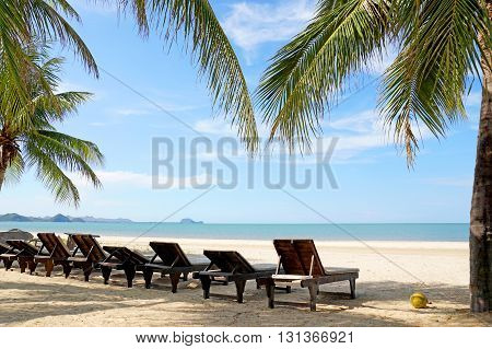 Beach Chairs And Coconut Palm Tree At The Tropical Beach, Pranburi, Thailand.
