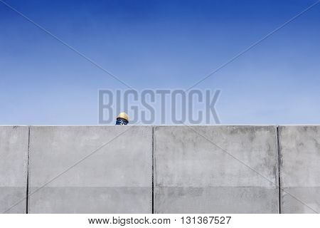 back side of the worker headback side of the worker hrad with the safty hat in the high way construction site with the blue sky