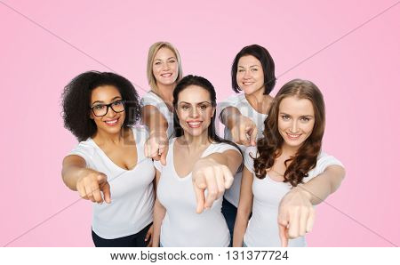 choice, friendship, body positive, gesture and people concept - group of happy different size women in white t-shirts pointing finger on you over pink background
