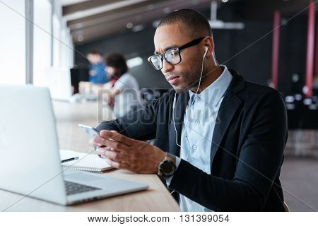 Concentrated handsome young businessman received bad news on the the smartphone during work process