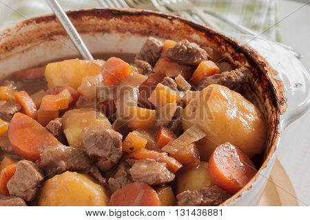 Hearty meat and vegetable stew a traditional dish containing meat gravy potatoes turnips onions and carrots
