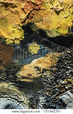 some dried oil colors on a palette close up abstract