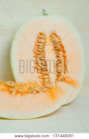 Sliced cantaloupe or Charentais melon or Cucumis melo var. cantalupensis on wooden board background