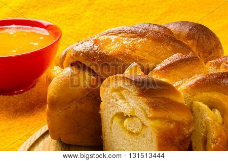 peach strudel to a wooden Board with natural honey in a red bowl