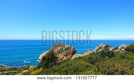 Gigantic rocks chaotic cross the plains. Ocean coast.