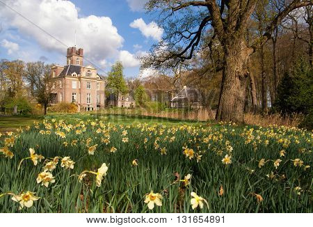 Oldenaller castle near the Dutch village Putten surrounded by daffodils