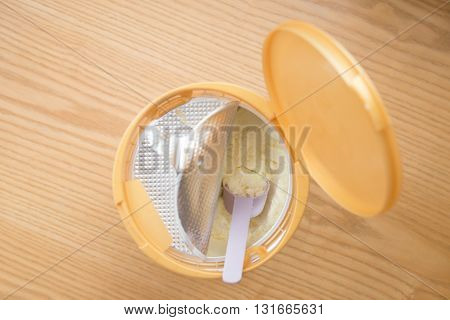 can of powdered milk for children on wooden table