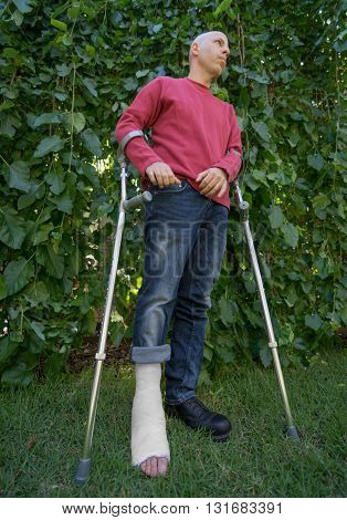 Young Man With A Leg Cast In A Garden