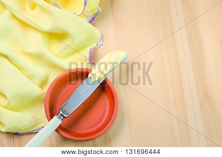 a butter on the knife on wod background