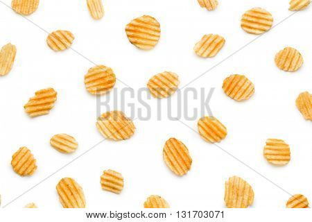 Crinkle cut potato chips isolated on white background. Tasty spicy potato chips.