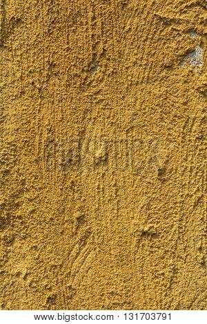 The texture of yellow clay wall for background..