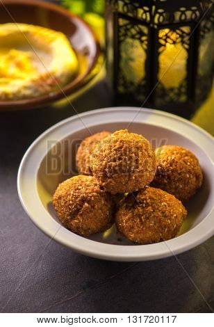 Bowl of falafel and hummus and lantern. Food during holy month of Ramadan.