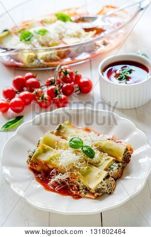Cannoli with spinach and cheese on rustic background