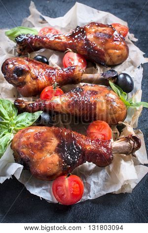 Photos of crunchy chicken legs on rustic background
