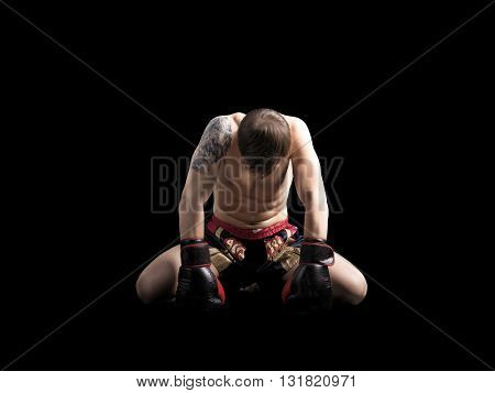 Muscular caucasian muay thai fighter isolated on black background