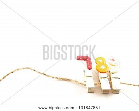 Wooden paper clips on brown string with seven eight nine popular telephone number for thai people believed in lucky number concept
