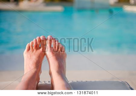 Close up of female feet on white sandy beach