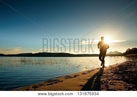 Sportsman Running At Amazing Summer Sunset Along Coastline In Sport And Healthy Life  Style