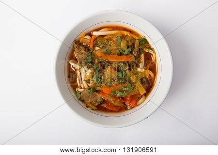 Uzbeck traditional soup on a white background