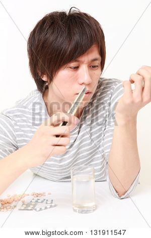 portrait of young Japanese man suffers from a neurosis on white background