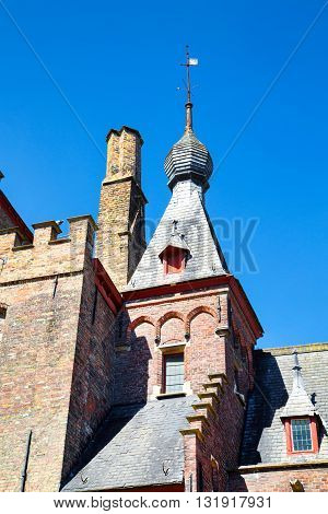 Traditional medieval  brick house exterior against blue sky in belgian destination Brugge, Belguim