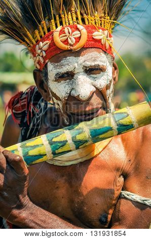 Old Man With Flute In Papua New Guinea